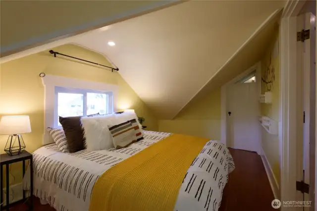 Bedroom No. 1 upstairs is defined by having the most pronounced vaulted/dormered ceilings of the home, which lends a coziness to the space. Through the door straight ahead you'll find a small office/study/play space.