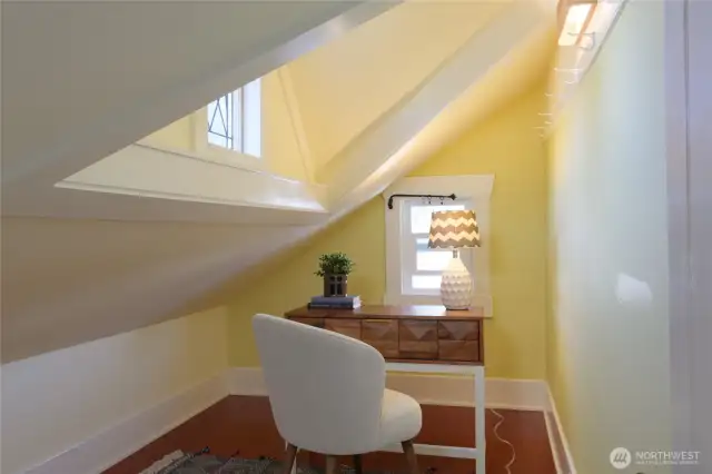 The first room you'll encounter in the upstairs has this dormered space which serves as a small study, storage, or play area.