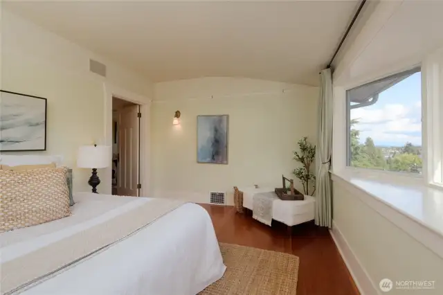 An expansive bay window opens the main bedroom to the outdoors and pulls in a view toward Green lake (yes, you can see the lake) and on clear days, Mt Rainier.