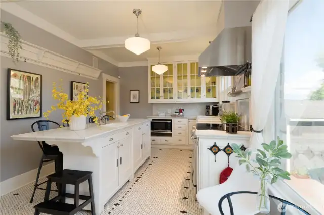 With short hallways and stairwells at either end, the kitchen is, both literally and figuratively, the central hub of this home.