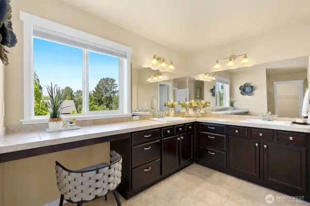 Primary en suite offers double sinks, vanity space and plenty of storage.