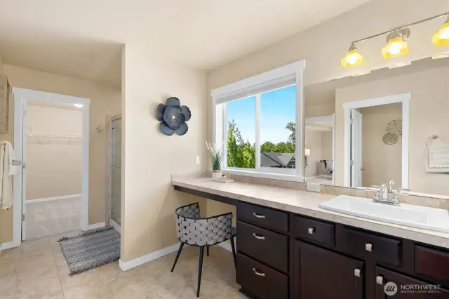 Another view of primary en suite with walk in shower and spacious walk-in closet.