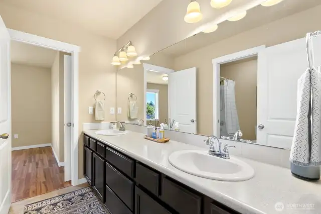 Jack in Jill bath offer double vanities, good storage and private shower / toilet room. Entrance to adjoining bedroom at far side.