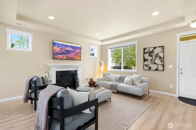 Main living room offers ample natural light, great space & cozy gas fireplace.
