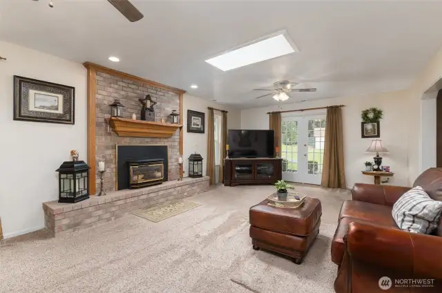 Big living room is warmed by the convenience of a gas fireplace