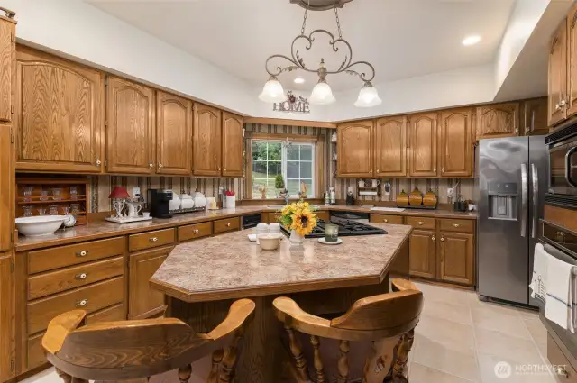 Many cabinets and a convenient island grace the Chef's Kitchen