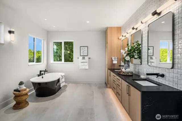 The Primary Bath and walk-in closet offer a luxurious retreat, featuring heated floors for added comfort. Indulge in the double-head walk-in shower, unwind in the spacious soaking tub, and enjoy the elegance of a granite double sink vanity with a stunning waterfall edge. For extra luxury, a heated towel rack completes this spa-like experience.