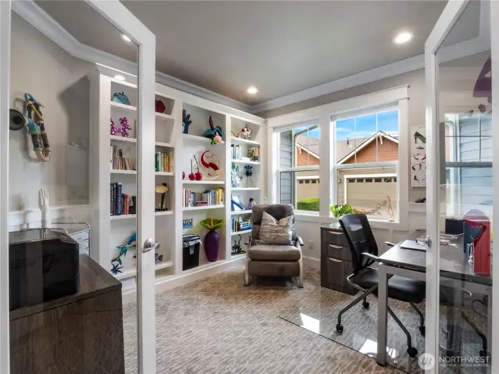 The den has custom built ins and large French doors welcomes you in.