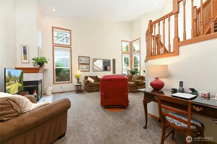 Warm wood wrapped windows and stair rails.