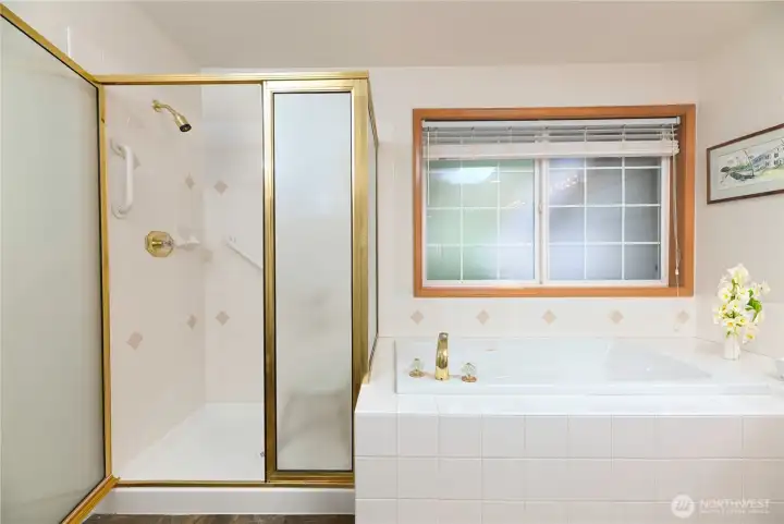 Primary bath with jetted tub and double sink vanity.