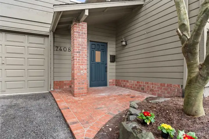 Charming brick front entry featuring a newly painted front door.