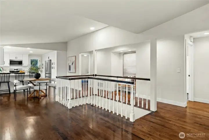 Spacious upstairs with bright open layout and stair railing feature.