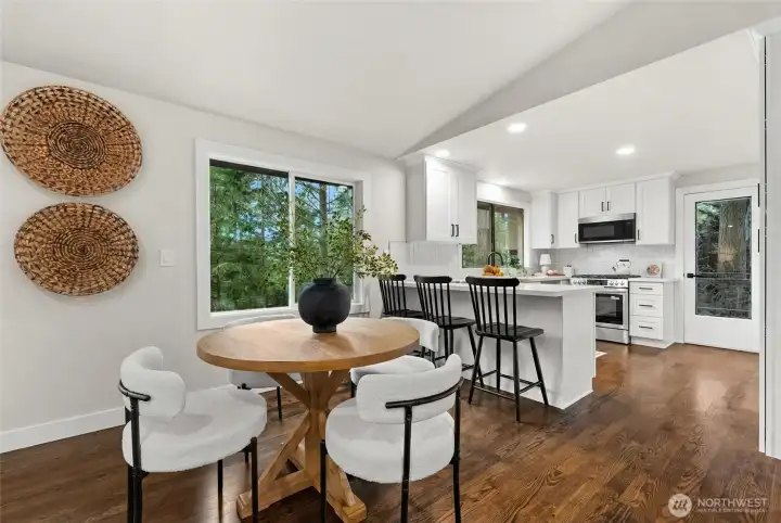 Bright dining space featuring bar seating and easy kitchen access.