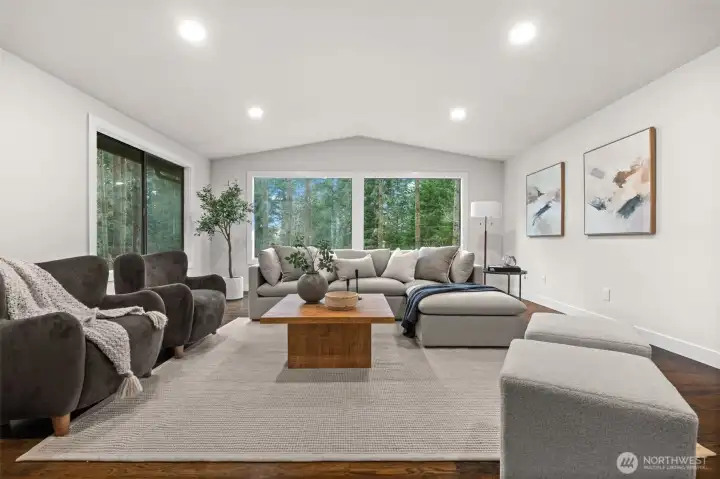 Bright upstairs living space with large windows and room for activities.