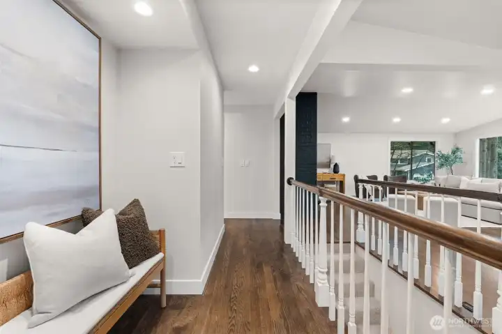 Cozy hallway nook with storage/reading space and adjustable wall thermostat.