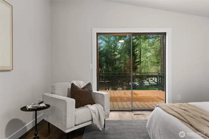 Main bedroom with direct deck access through sliding glass door.