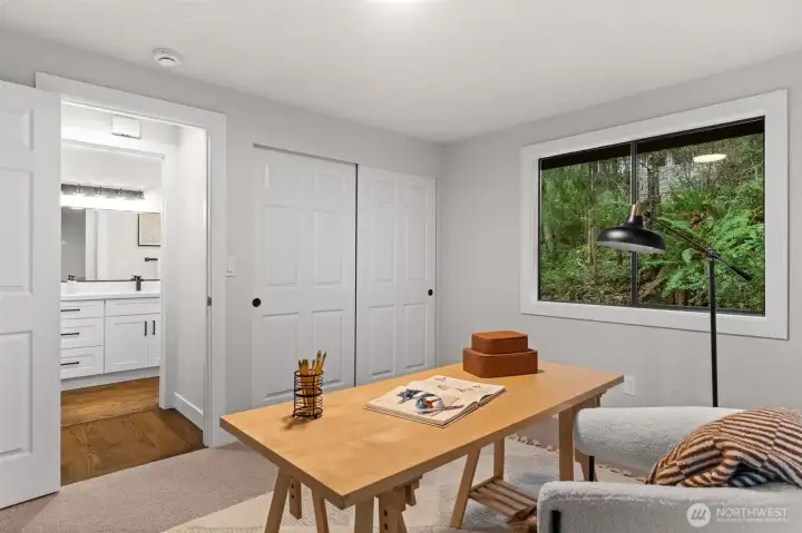 Room on main level with closet, updated carpet, and nearby full bath.