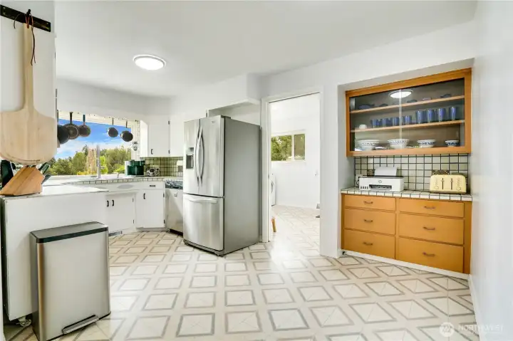 Modern convenience blends with timeless character—featuring updated appliances and charming period built-ins with glass-front cabinets perfect for display. Thoughtful layout offers options for expansion, giving you room to grow and personalize the heart of the home.