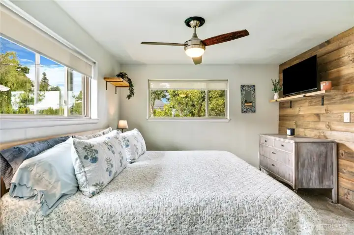 A blend of comfort and character—newer carpet grounds the main floor bedroom while shiplap adds texture and style. Let the natural light do the rest.