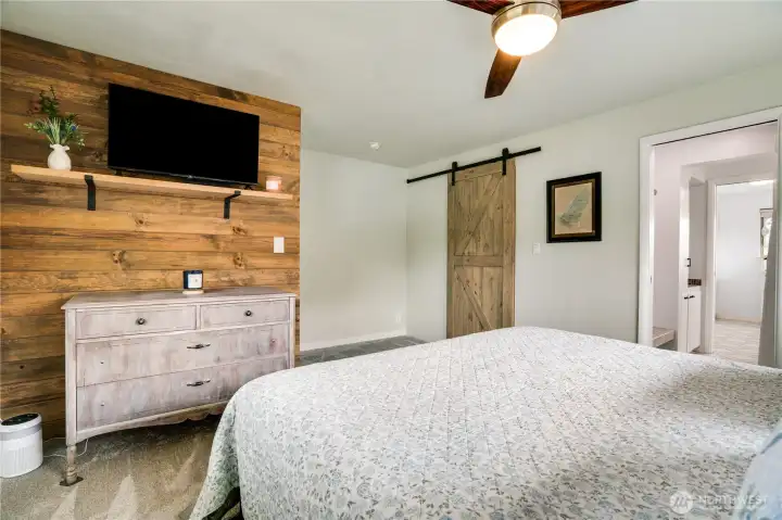 Slide open the barn door and step into an organized dream with modern shelving, ample hang space, and the warm scent of cedar.