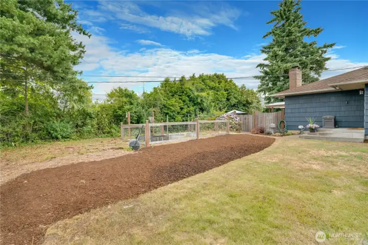 Already set up for success, the fenced beds in the front yard are perfect for planting, tending, and watching your garden thrive. This ideal Northern location means afternoon sun and light!