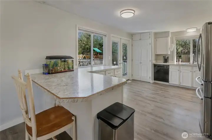 French doors provide great access to large all-weather deck and the fenced backyard.