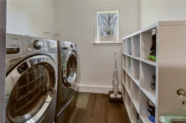 Full-sized laundry make up the other end of the transition space between garage and kitchen.