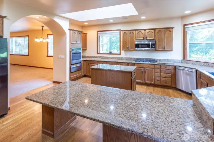 Kitchen from entrance with built-in oven and French door refrigerator