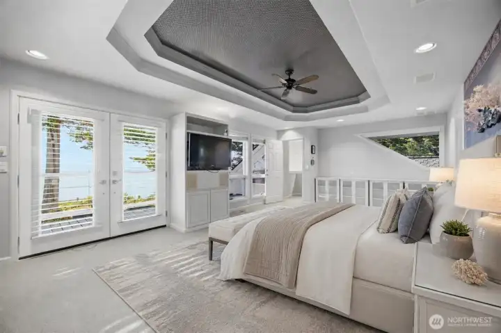 primary bedroom with 2 on suite bathrooms & fireplace looking west , private deck