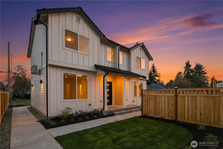 Evening exterior highlighting warm interior light and modern architecture