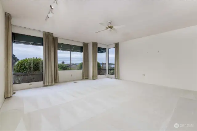 HUGE sunken Living Room  Floor to ceiling window wall with AMAZING views overlooking rear yard with PovertyBay view
