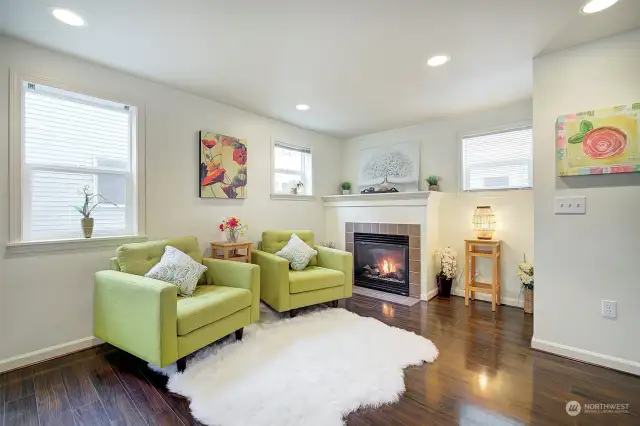 Cozy gas fireplace lights up this comfortable living room area