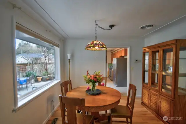 Dining room off the kitchen with refinished wood flooring.