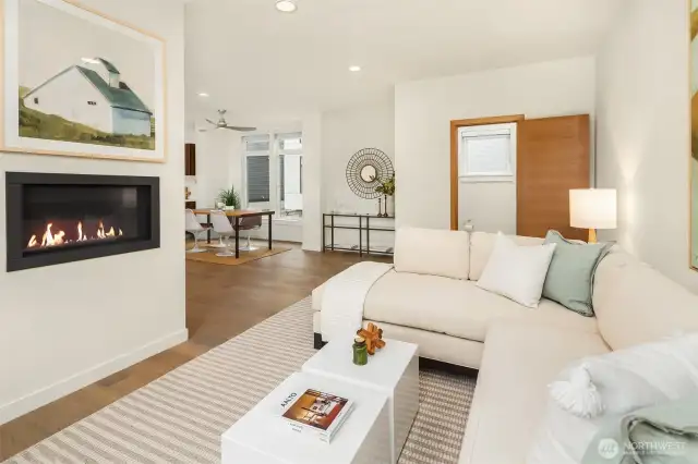 A view of the living room facing the dining area and 1/2 bath.