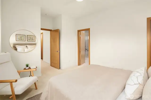 The primary bedroom offers a large ensuite bathroom and walk-in closet to the right.