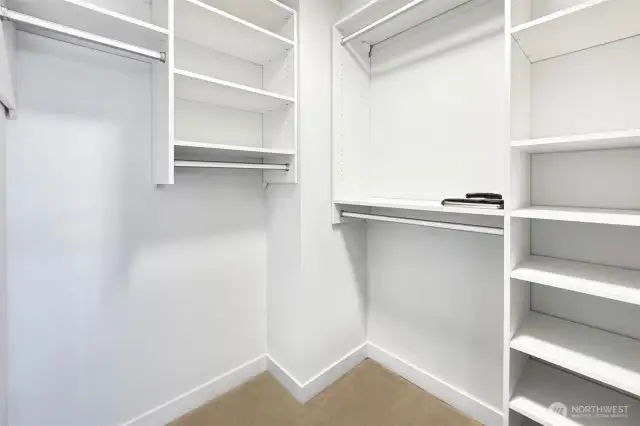 Primary closet is huge and features custom closet design