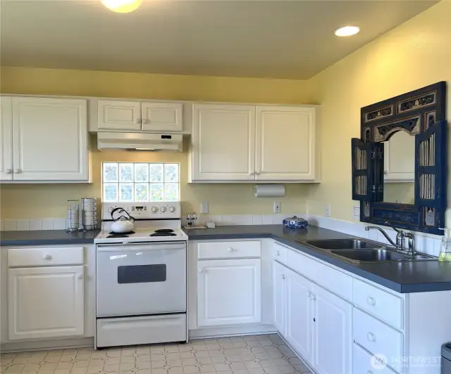 Inside is a bright and cheery kitchen with lots of counter space and cabinets.