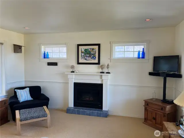 Just off the kitchen is a spacious living room with a propane fireplace that has an auto switch to turn it on and off.