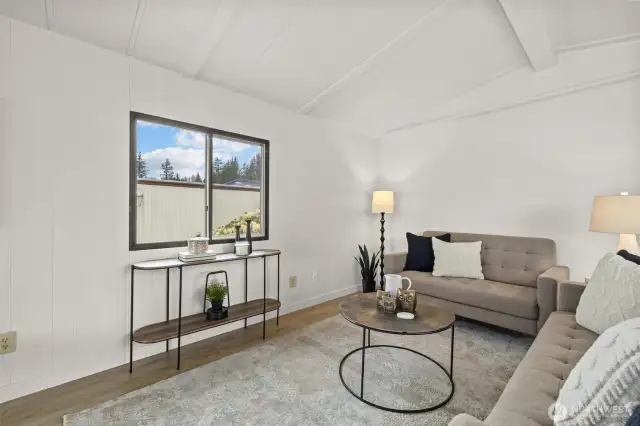 Living room offers fresh paint, LVP floors throughout and a wood burning fireplace.