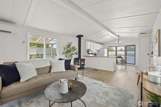 Living room offers fresh paint, LVP floors throughout and a wood burning fireplace.