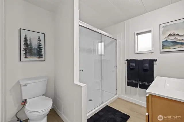 Renovated bathroom with walk in shower, new vanity and toilet.