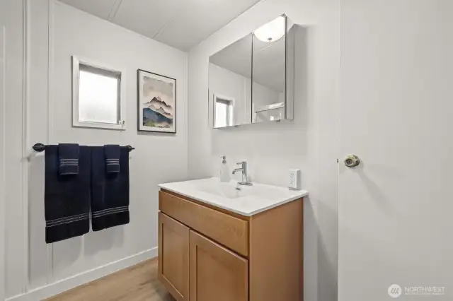 Renovated bathroom with walk in shower, new vanity and toilet.