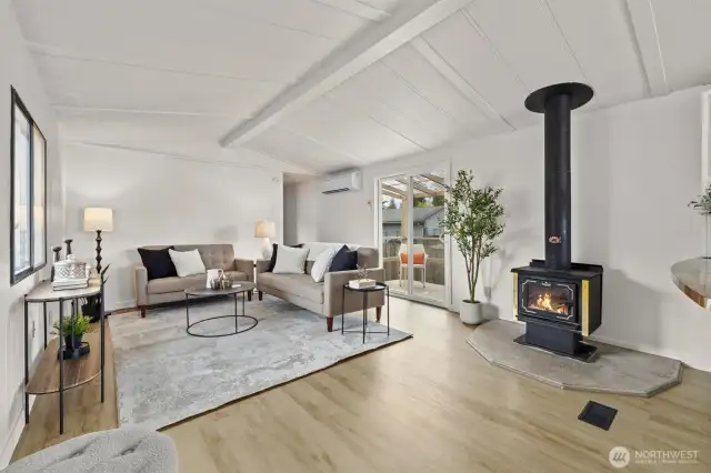 Living room offers fresh paint, LVP floors throughout and a wood burning fireplace.