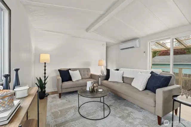 Living room offers fresh paint, LVP floors throughout and a wood burning fireplace.