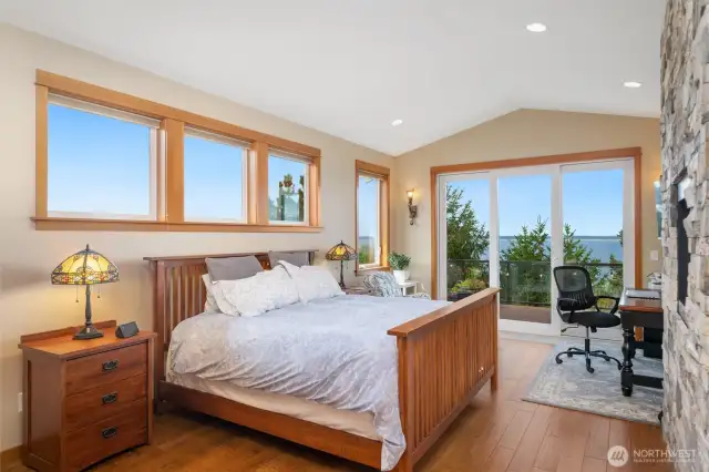 Primary Suite has an entry point to the spacious deck. a gas fireplace and fir trimmed windows that offer so much natural light.  Engineered cherry hardwood floors.
