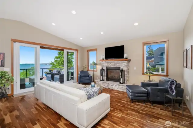 Living Room offers Vaulted ceilings, Acacia Floors, Entry point to deck via four panel french doors, Rock faced gas fireplace, and a wet bar.