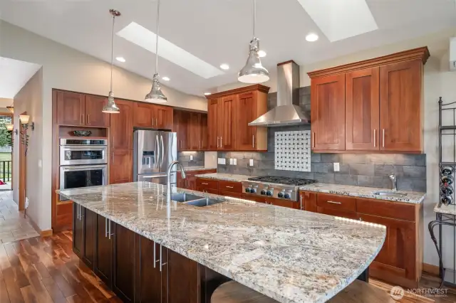 Entertainers Delight kitchen with cherry cabinetry, 2 skylights, 5 burner gas stove, granite countertops and Stainless appliances.