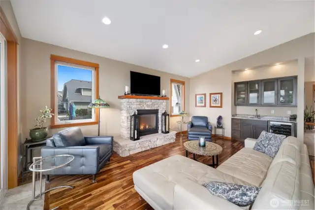 Living Room offers Vaulted ceilings, Acacia Floors, Entry point to deck via four panel french doors, Rock faced gas fireplace, and a wet bar.