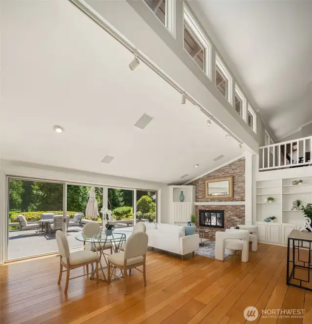 Bright family room with floor-to-ceiling windows overlooking pristine golf greens