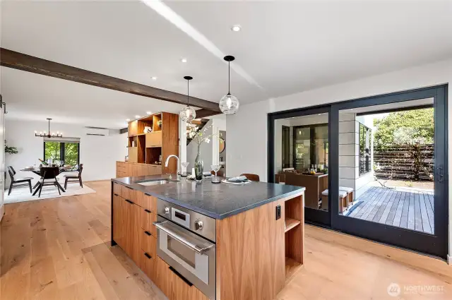 The kitchen equipped with premium appliances,and a seamless transition to a private deck